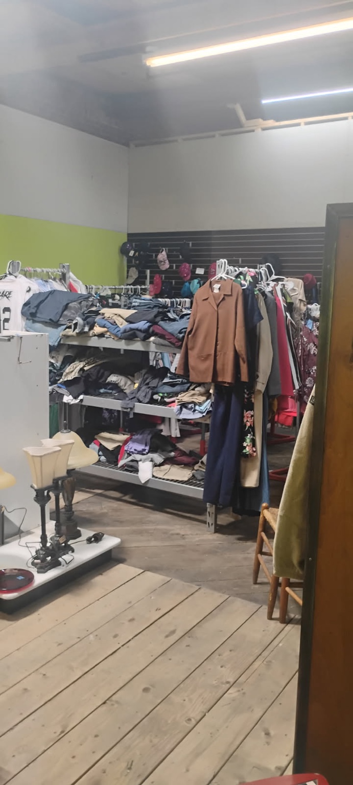 Clothing racks and folded items on display